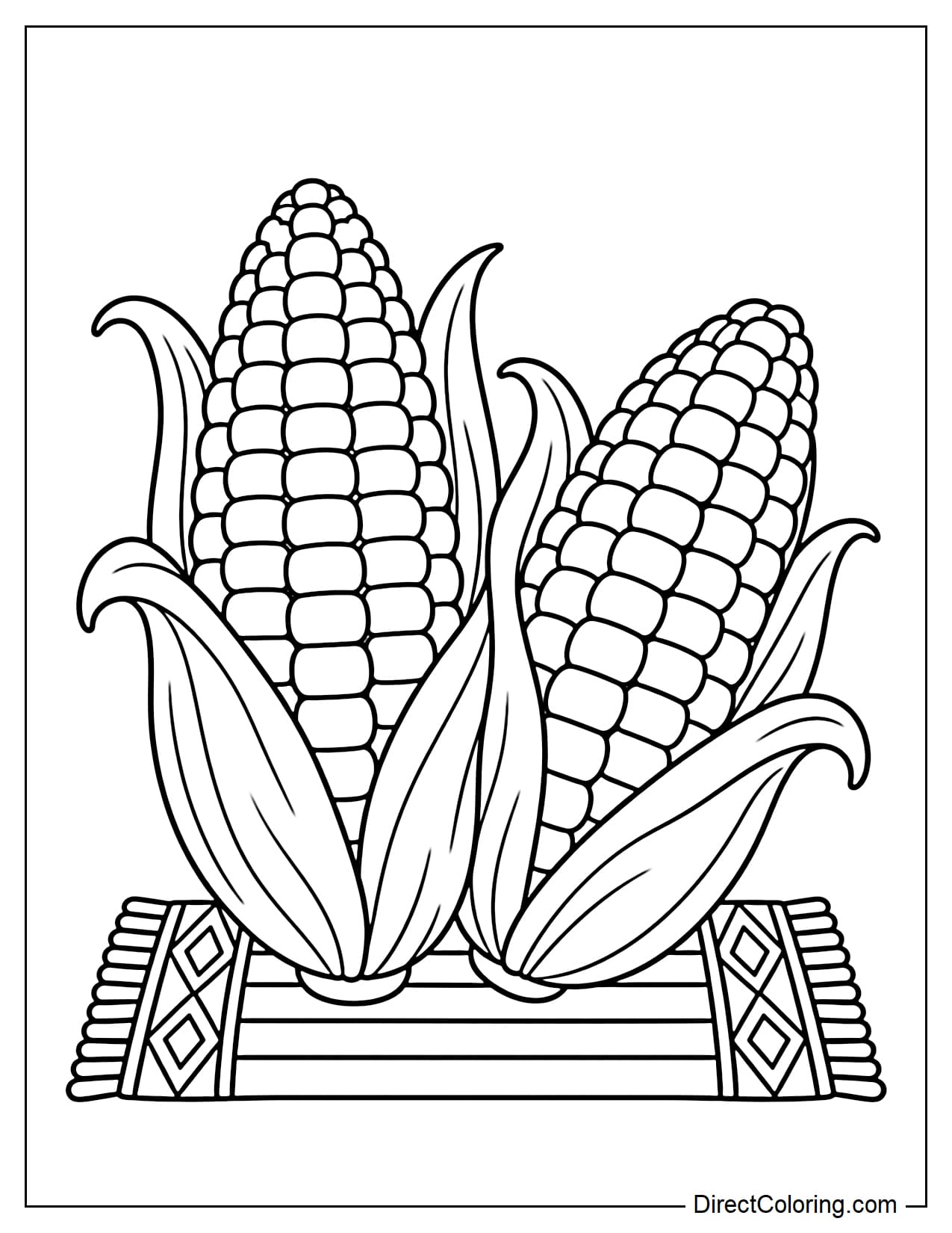 Two large ears of corn with their husks intact rest on a small Mkeka mat decorated with diamond patterns, with the word 