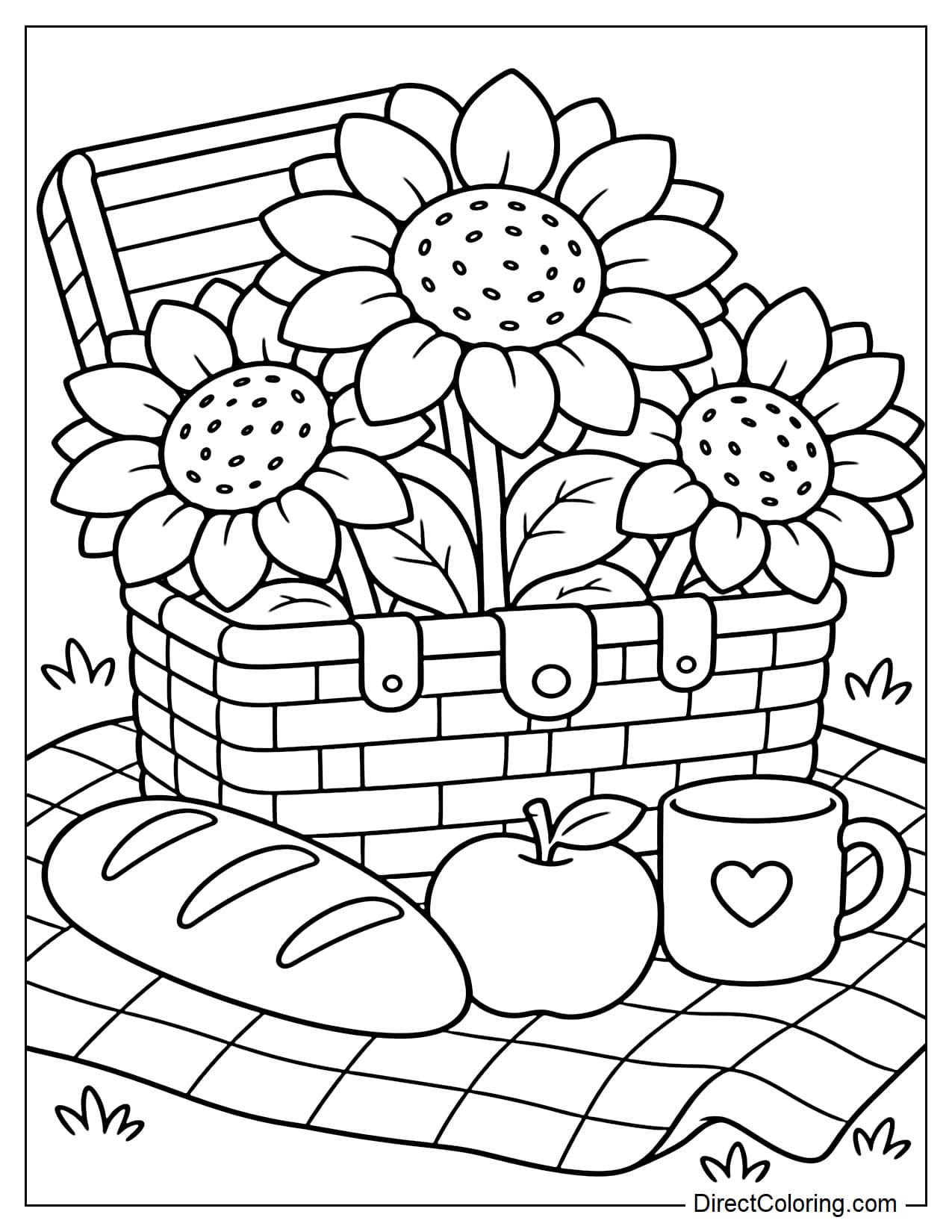 A large open wicker picnic basket filled with three sunflowers spreading their petals outward. A baguette, an apple, and a round cup sit beside the basket, all arranged on a picnic blanket with large checks.